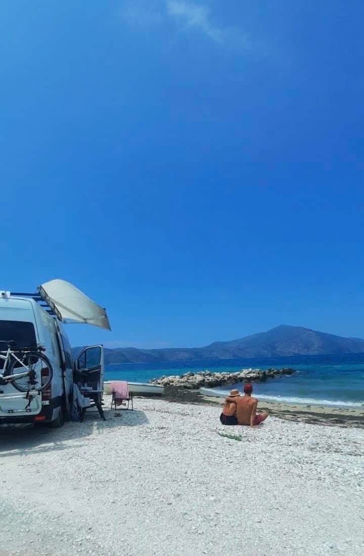 View from inside the camper toward an open natural landscape.